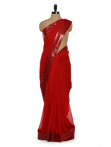 Solid red saree with sequined border