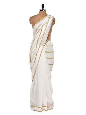 Gold trimmed ethereal white saree