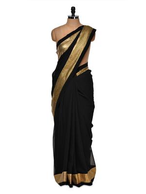 Luxe black saree with gold border