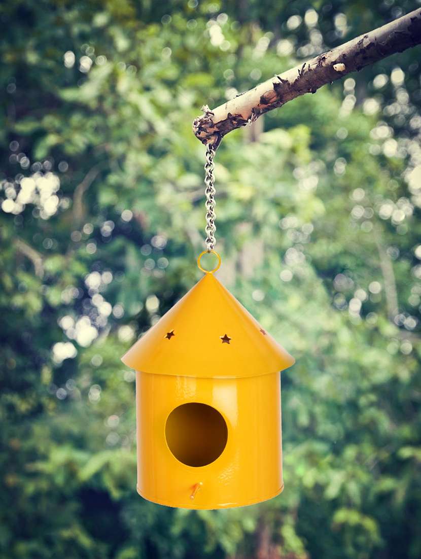 yellow metal bird house