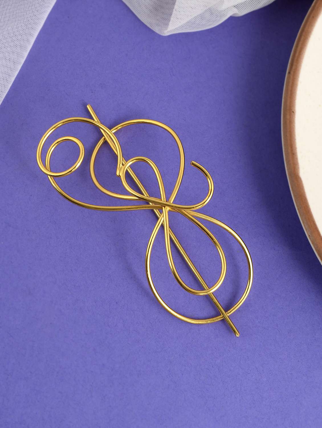 women gold toned embellished hair accessory