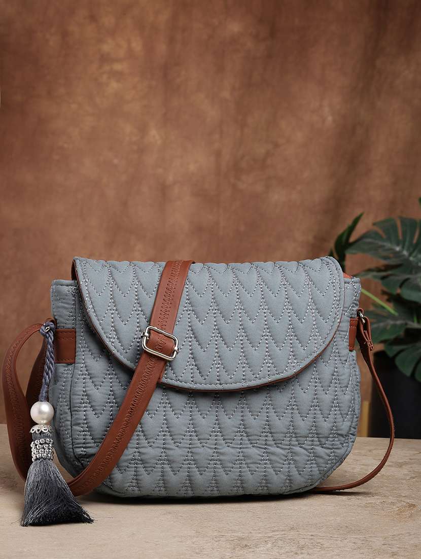 women textured sling bag