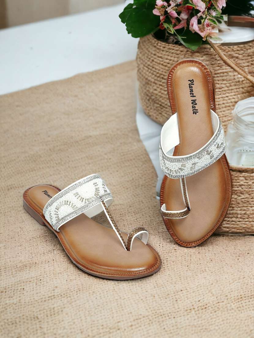 white synthetic slip on sandals