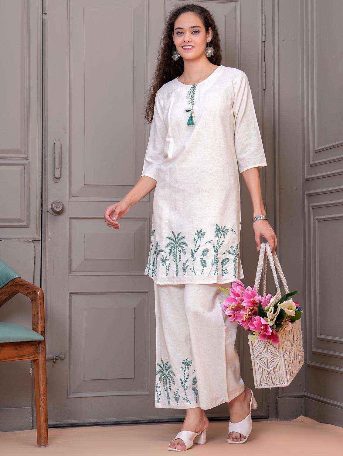 women embrpidered tie up neck kurta and palazzo set
