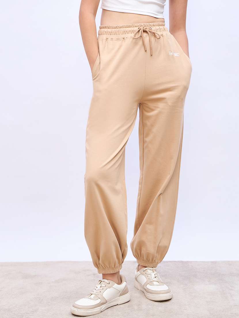 women beige solid mid rise jogger
