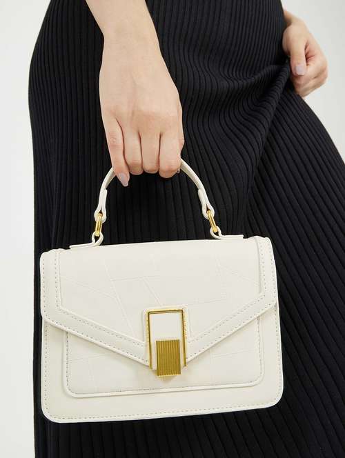 women cream solid handbag - 22176753 -  Standard Image - 0