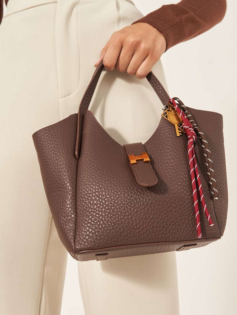 women brown solid handbag