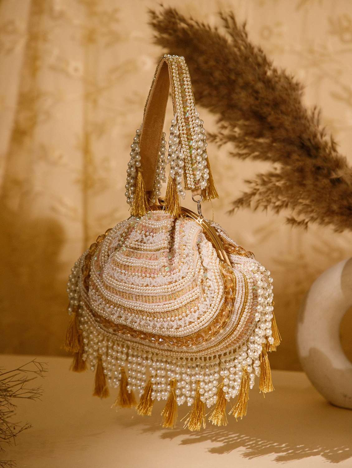 women gold embellished velvet party clutch with tassels