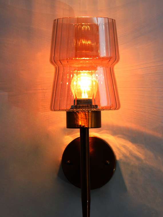 modern brass wall sconce with amber glass shade