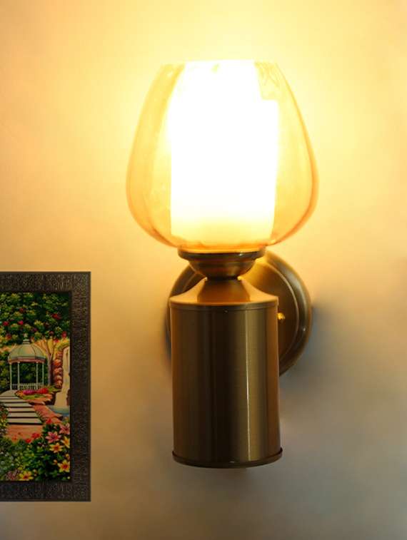 brushed brass wall sconce with amber glass shade