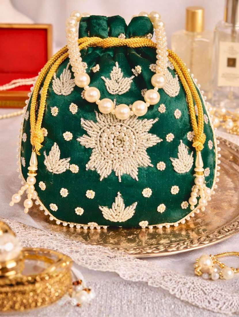 women solid with work embellished potli