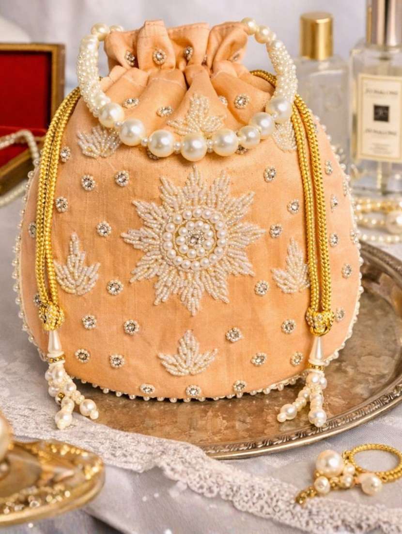 women solid with work embellished potli