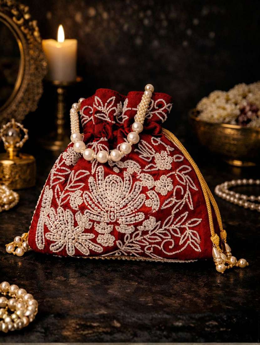 women solid with work embellished potli