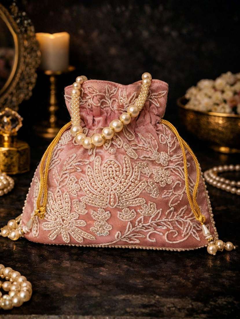 women solid with work embellished potli