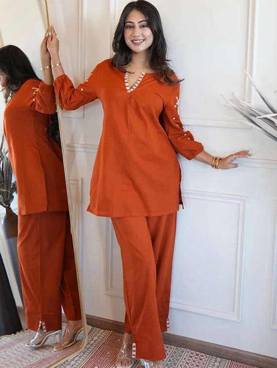 women orange kurta dupatta set