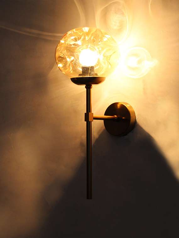 brass funner wall sconce with amber glass globe modern light