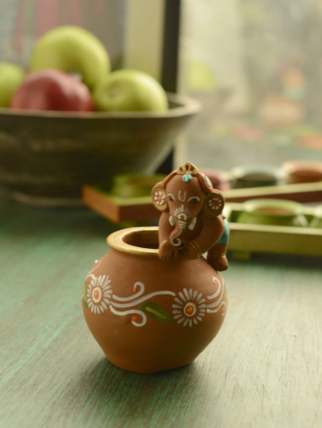 handpainted baby ganesha crawling on the matki