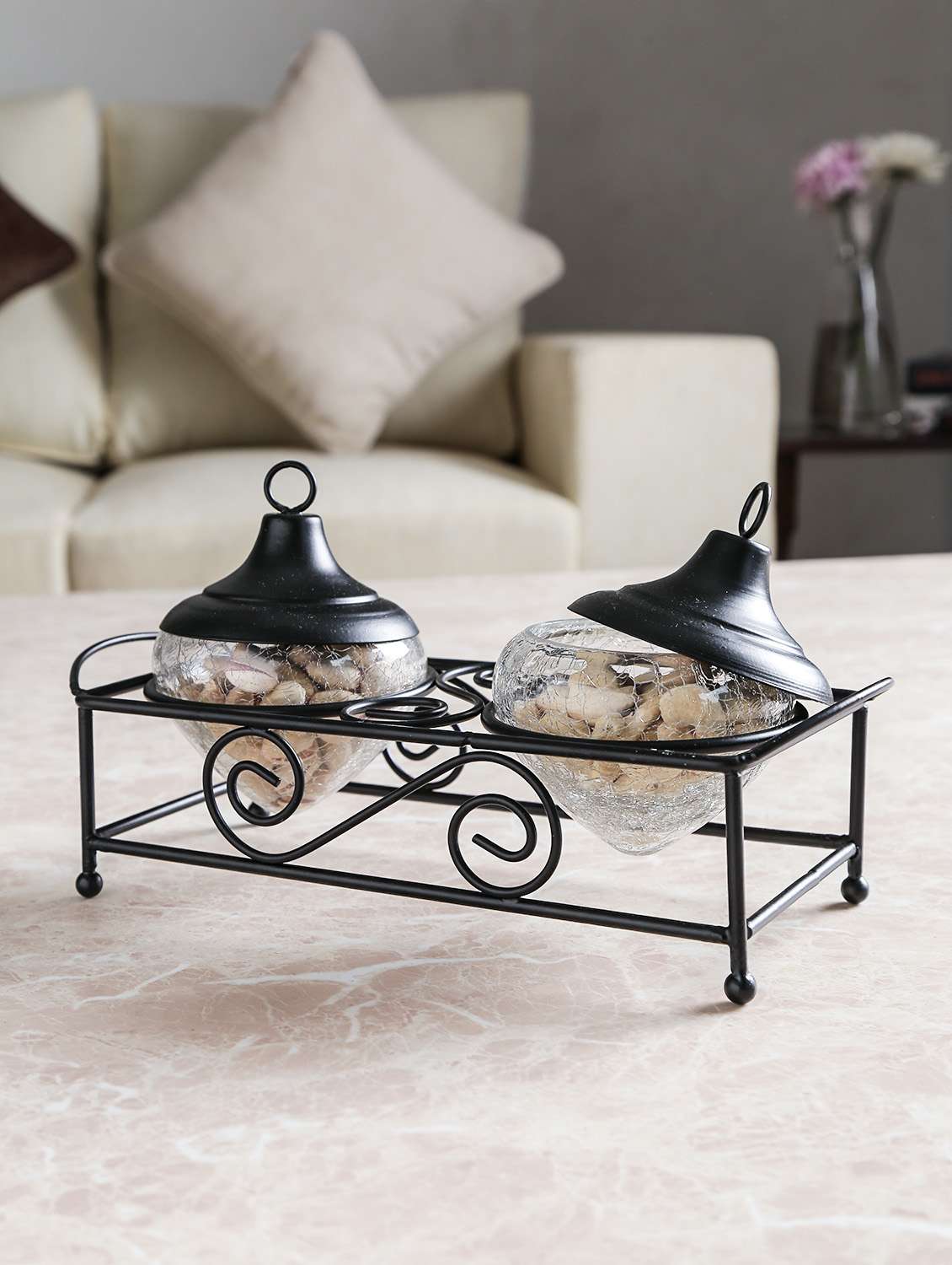 black colored, table accessory made up of wrought iron and glass